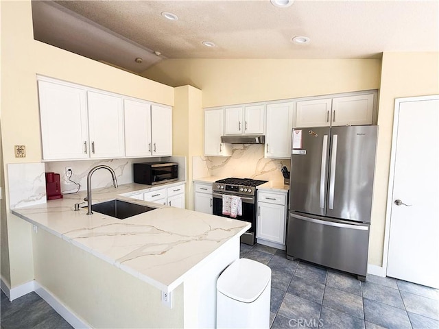 kitchen with a sink, light stone counters, white cabinetry, stainless steel appliances, and a peninsula