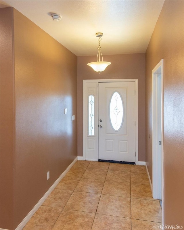 entrance foyer featuring light tile patterned floors and baseboards