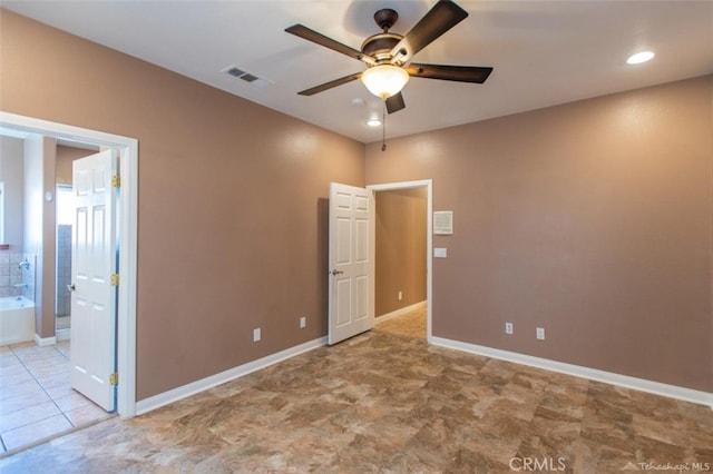 unfurnished bedroom featuring visible vents, connected bathroom, and baseboards