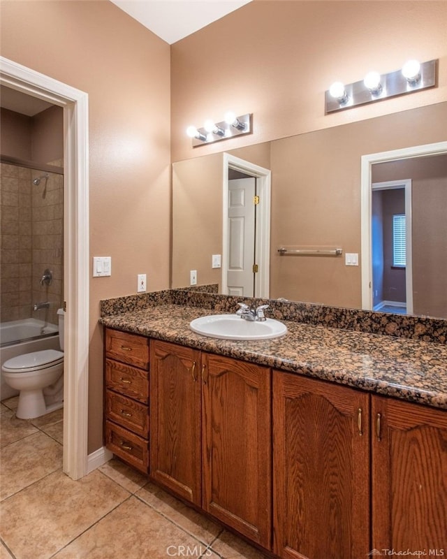 bathroom with tile patterned flooring, toilet, vanity, and bathing tub / shower combination