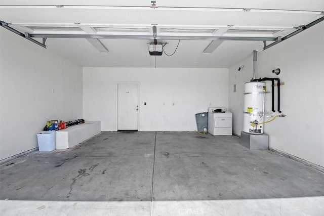 garage with strapped water heater, washer / dryer, and a garage door opener