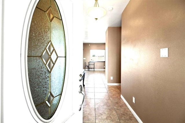 hall with light tile patterned floors and baseboards