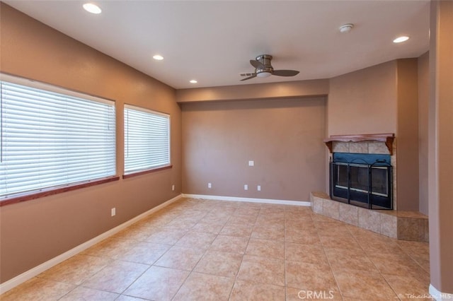 unfurnished living room with baseboards, light tile patterned flooring, recessed lighting, a fireplace, and ceiling fan