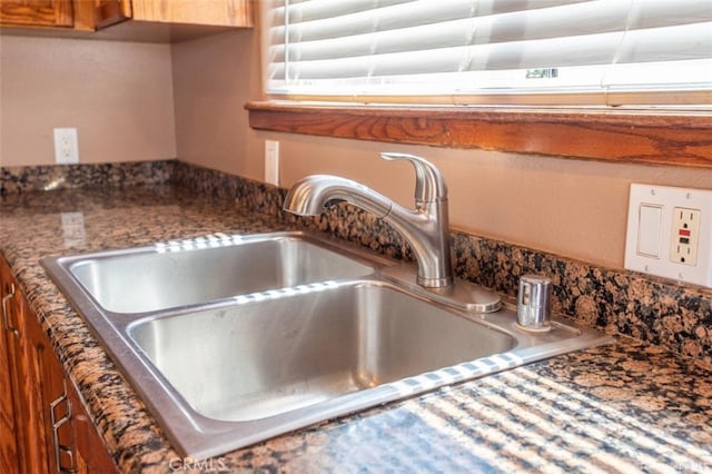 room details with a sink and brown cabinetry