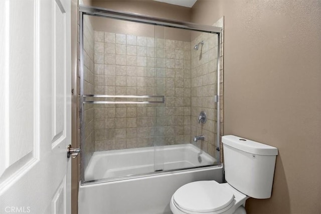 bathroom with toilet and enclosed tub / shower combo