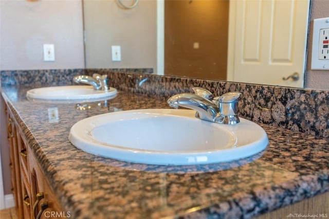 bathroom featuring double vanity and a sink