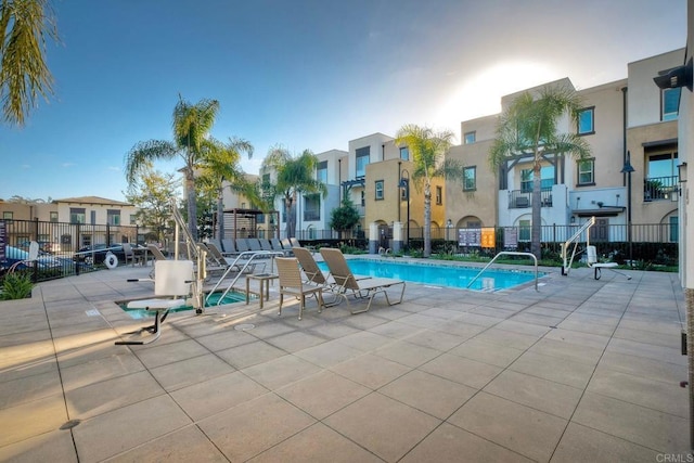 pool with fence, a residential view, and a patio area