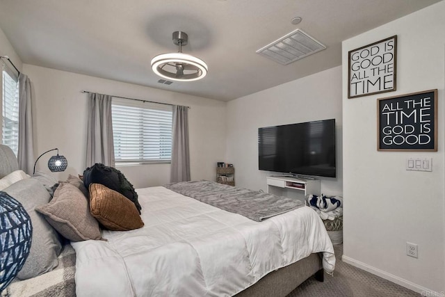 carpeted bedroom featuring baseboards and visible vents
