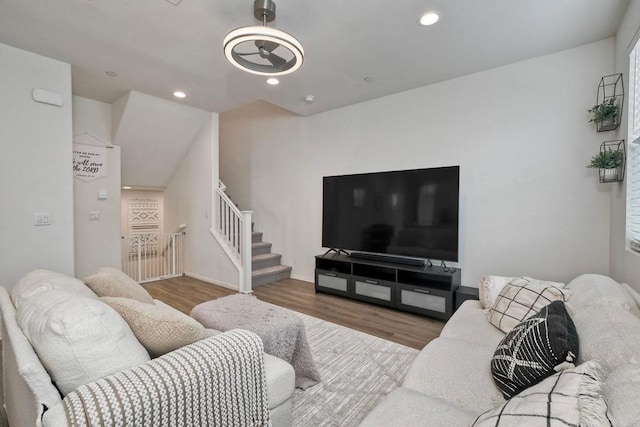 living area featuring stairs, recessed lighting, and wood finished floors