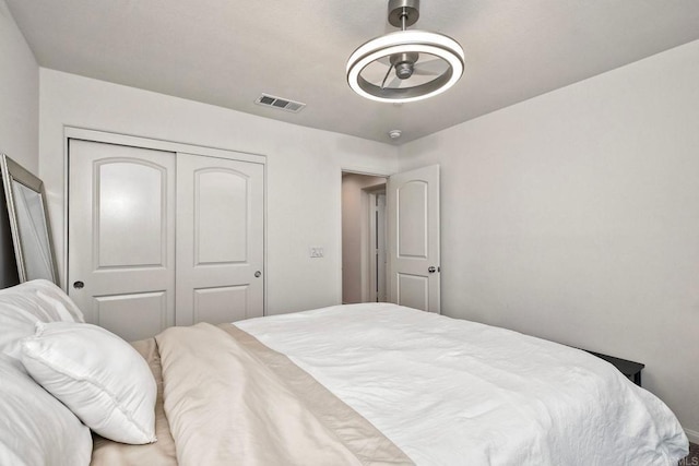 bedroom with visible vents and a closet