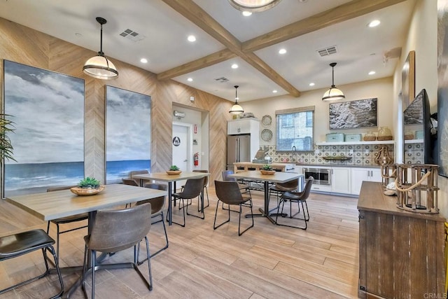 dining room with visible vents, light wood-type flooring, recessed lighting, and beamed ceiling