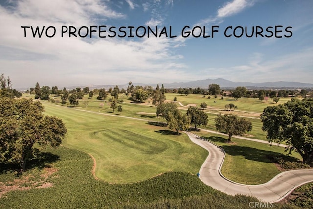 aerial view featuring view of golf course and a mountain view