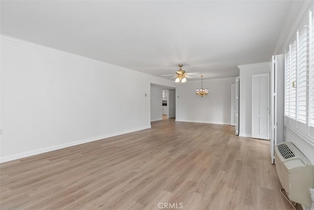 unfurnished living room with ceiling fan with notable chandelier, baseboards, light wood-style floors, and ornamental molding