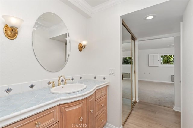 5519 Paseo Del Lago E Unit 2H, Laguna Woods, CA 92637 - bathroom with crown molding, wood finished floors, vanity, and baseboards