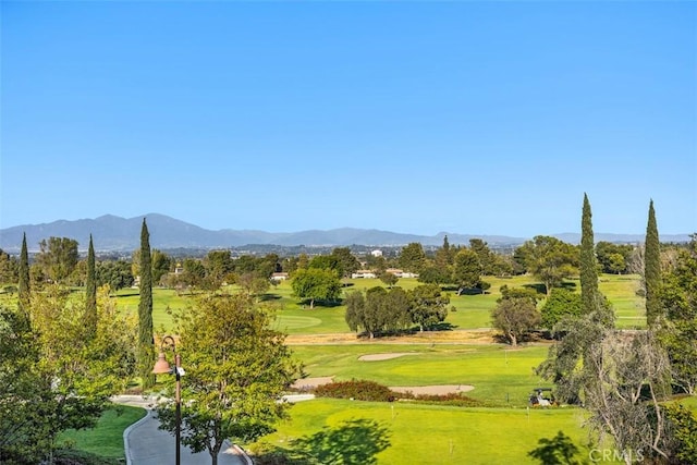 surrounding community featuring a lawn, golf course view, and a mountain view