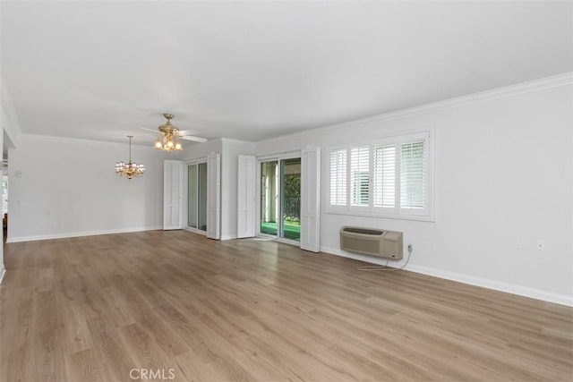 unfurnished room featuring crown molding, baseboards, light wood-type flooring, a wall unit AC, and ceiling fan with notable chandelier