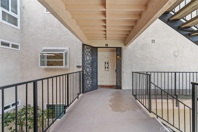 doorway to property featuring stucco siding