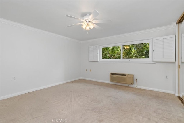 unfurnished room featuring a wall unit AC, baseboards, ceiling fan, crown molding, and carpet flooring