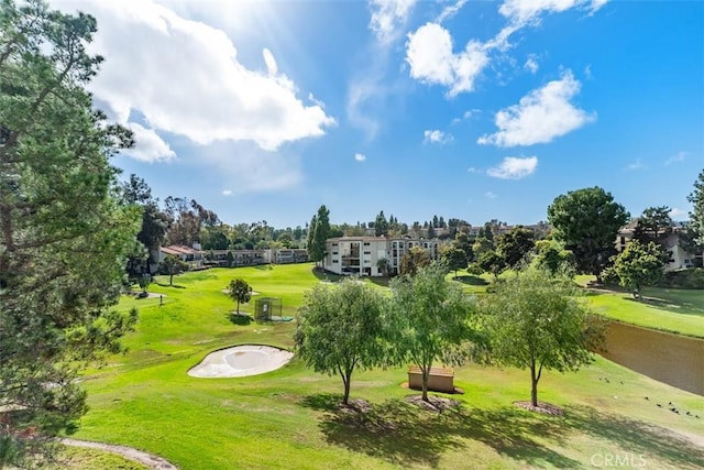 view of home's community with a yard and golf course view