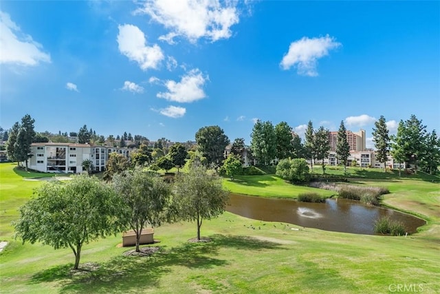 surrounding community featuring a lawn, golf course view, and a water view