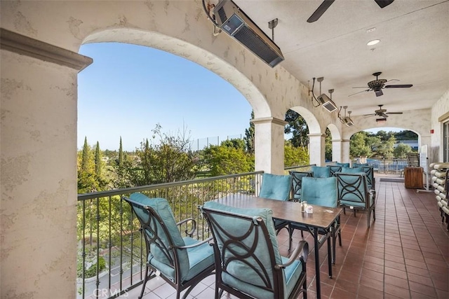 balcony with outdoor dining space and ceiling fan