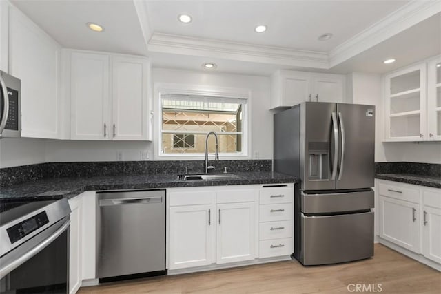 5519 Paseo Del Lago E Unit 2H, Laguna Woods, CA 92637 - kitchen featuring appliances with stainless steel finishes, a sink, a raised ceiling, crown molding, and white cabinetry