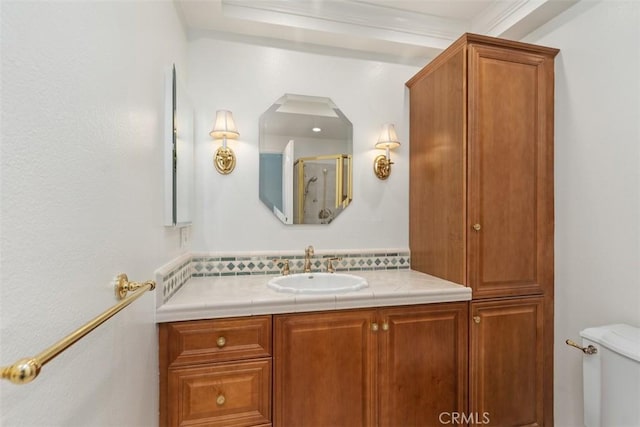 full bathroom with a shower with door, toilet, ornamental molding, and vanity