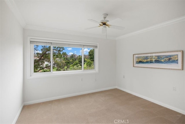 unfurnished room featuring crown molding, a ceiling fan, light colored carpet, and baseboards