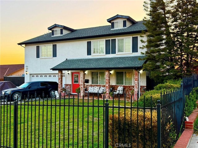 view of front of home featuring a garage, covered porch, and a fenced front yard