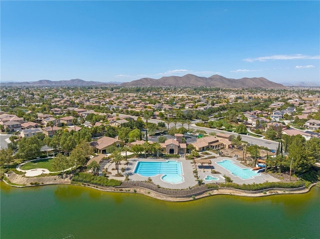 drone / aerial view featuring a residential view and a water and mountain view