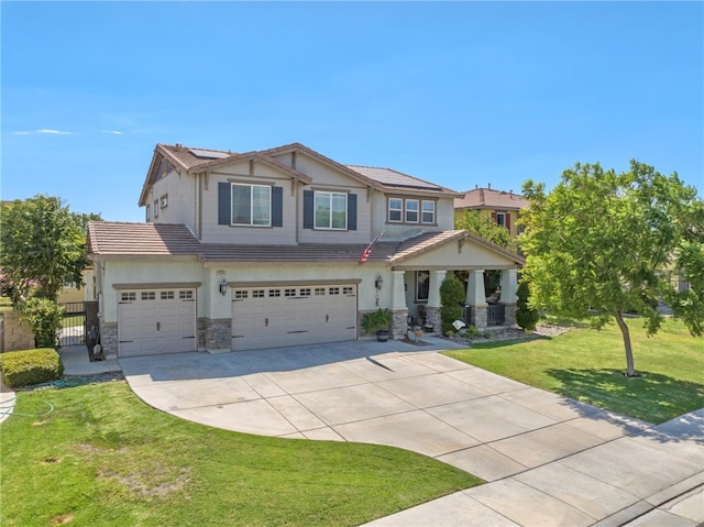 craftsman inspired home featuring stucco siding, a tile roof, stone siding, concrete driveway, and a front yard