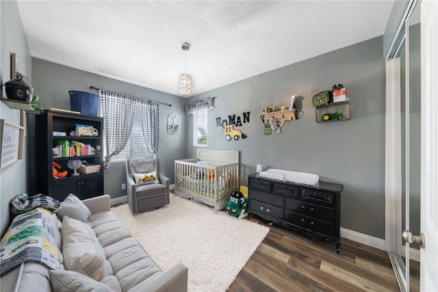 bedroom featuring baseboards and wood finished floors