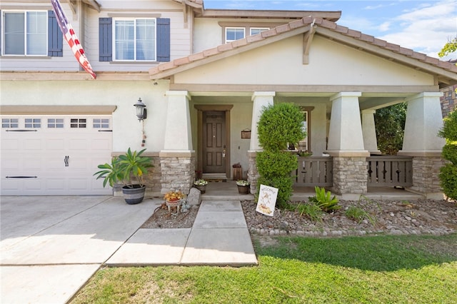 craftsman inspired home featuring a garage, a porch, and stucco siding