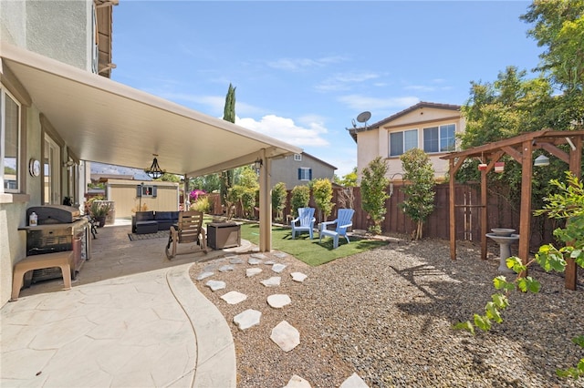 view of patio featuring outdoor lounge area, a fenced backyard, and grilling area