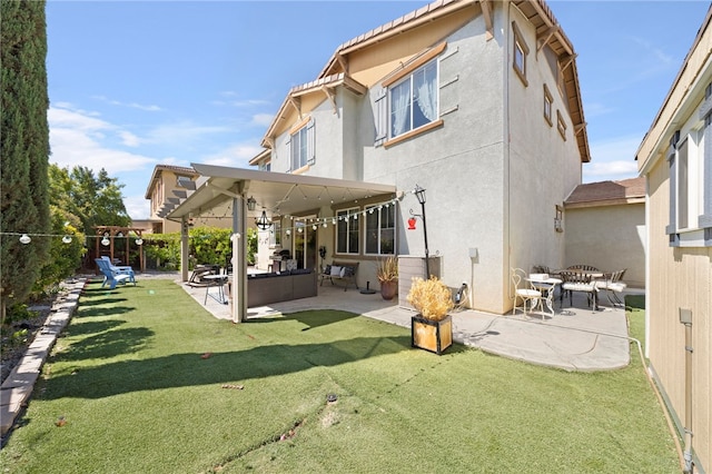 back of house featuring a yard, a patio area, a fenced backyard, and stucco siding