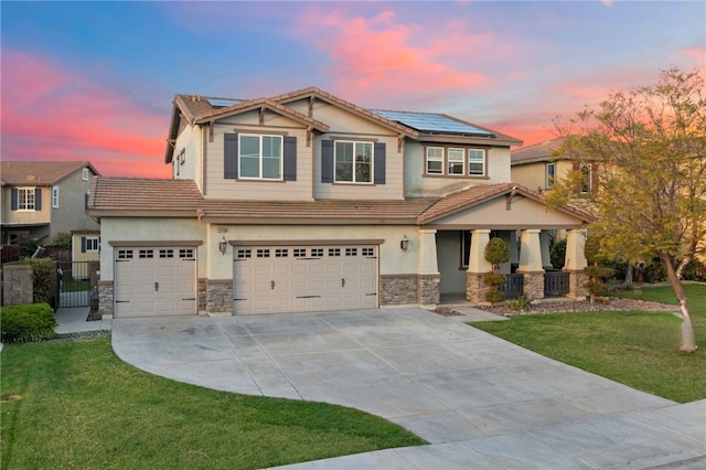 craftsman house with a tiled roof, a front yard, an attached garage, and concrete driveway