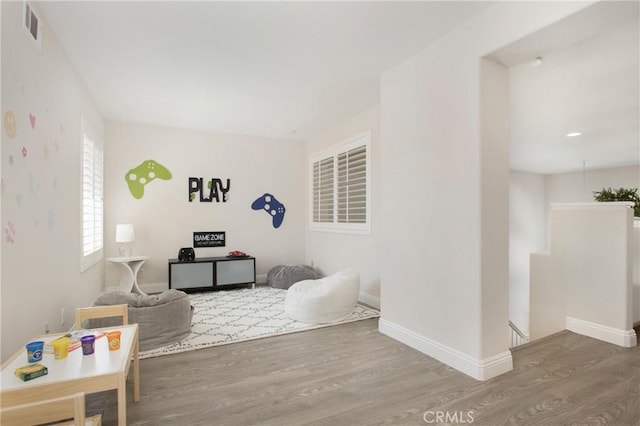 interior space with visible vents, baseboards, and wood finished floors