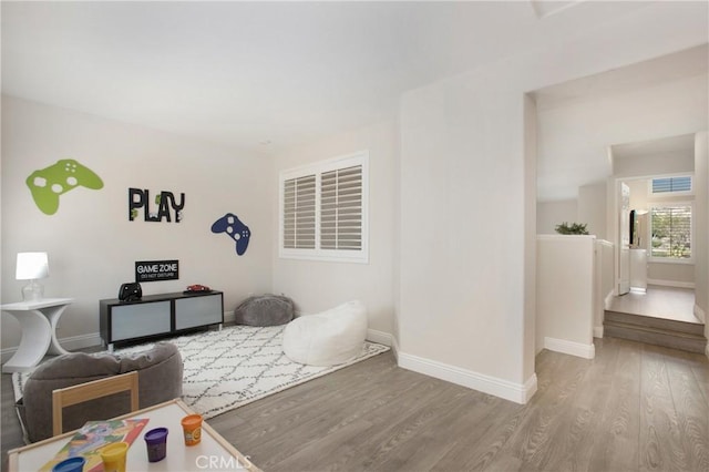 living room featuring visible vents, wood finished floors, and baseboards