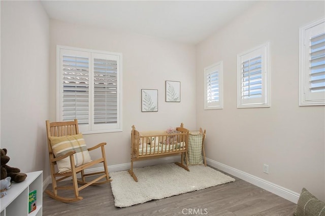 bedroom with baseboards and wood finished floors