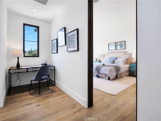 interior space with light wood finished floors, visible vents, and baseboards