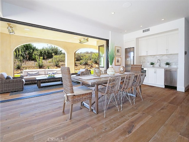 dining room featuring visible vents, recessed lighting, and light wood-type flooring