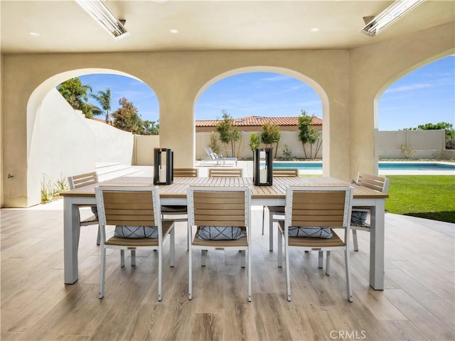 view of patio / terrace with a fenced in pool, outdoor dining area, and a fenced backyard