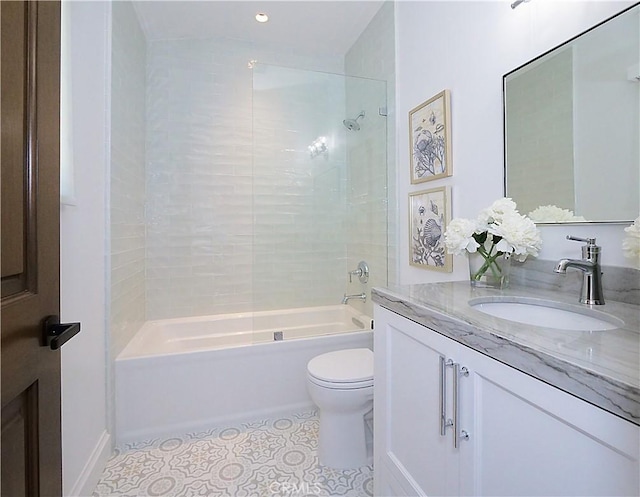 bathroom featuring tile patterned flooring, shower / washtub combination, toilet, and vanity