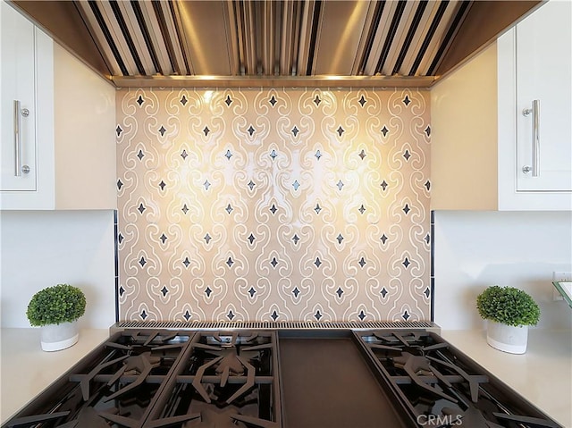 kitchen with custom exhaust hood and white cabinets