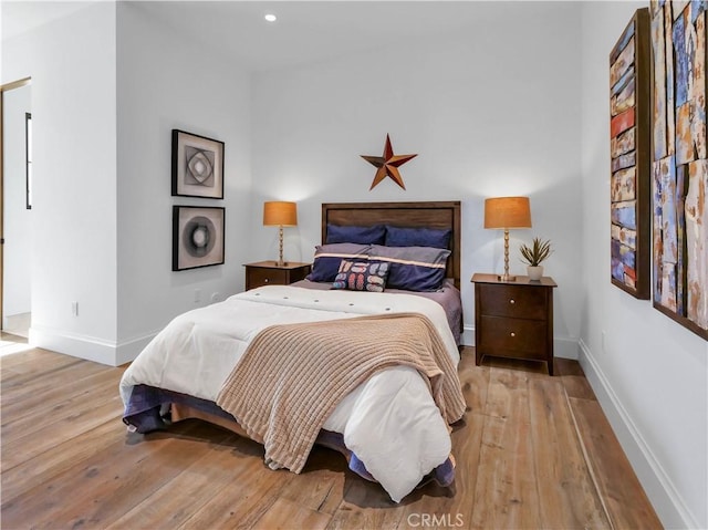 bedroom with recessed lighting, baseboards, and wood-type flooring