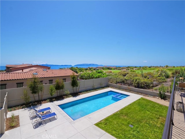 view of pool featuring a yard, a patio, a pool with connected hot tub, and a fenced backyard