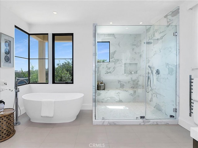 full bath with a freestanding tub, a marble finish shower, baseboards, and recessed lighting