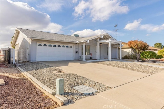 ranch-style house featuring concrete driveway, a gate, an attached garage, and fence