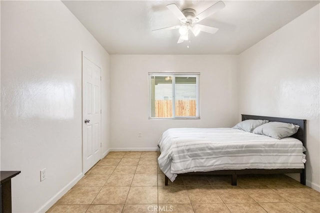 bedroom featuring light tile patterned floors, a ceiling fan, and baseboards