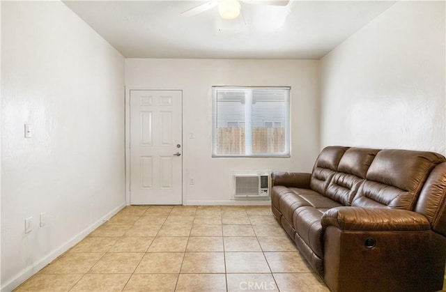 living area with light tile patterned floors, baseboards, and a ceiling fan